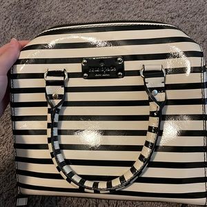 Kate Spade black and white stripped purse. Cross-body capability.